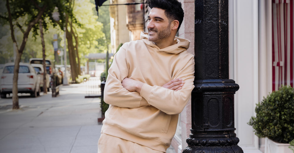 Man in a Sandlewood Deccan-Luxe hoodie and jogger on a city street