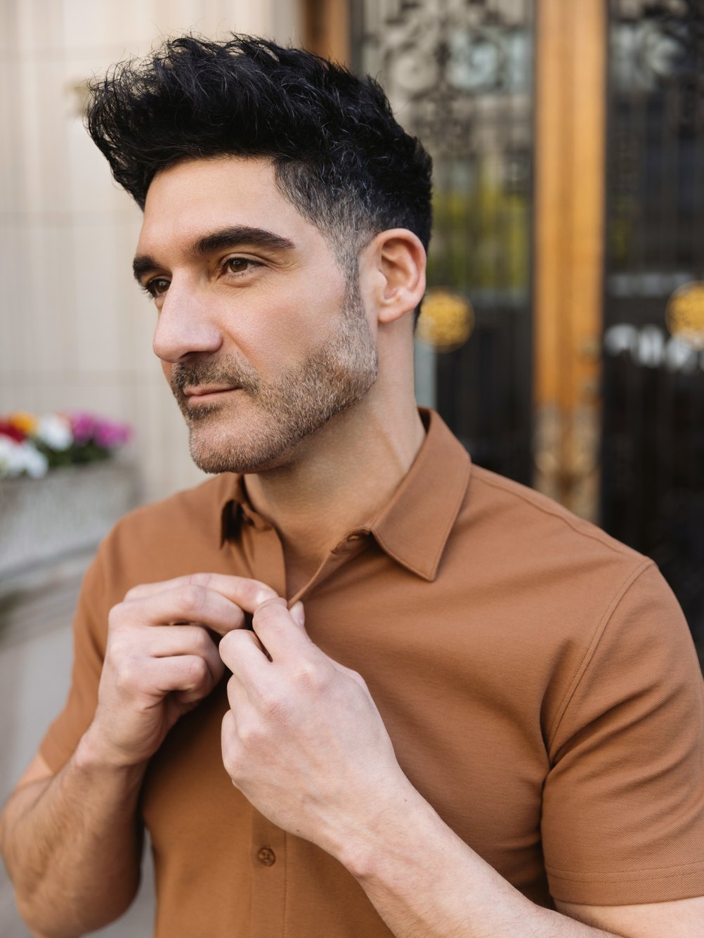 Man in a rust All-Day Shirt adjusting the collar