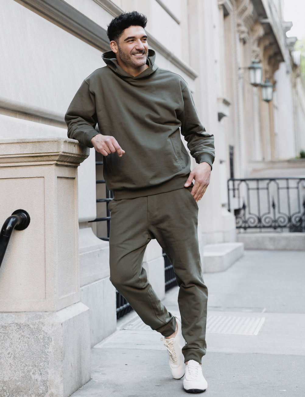 Man in a Sandlewood Deccan-Luxe hoodie and jogger on a city street