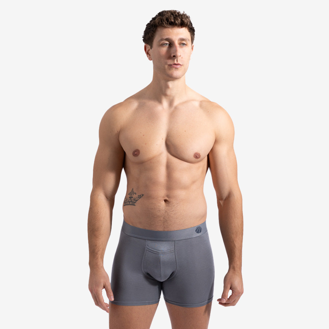 This image displays the Eco-Luxe Boxer Brief, designed for superior comfort and freshness throughout the day. Modelled by a fit male, the boxer brief is grey in color, showcasing a sleek and modern design.