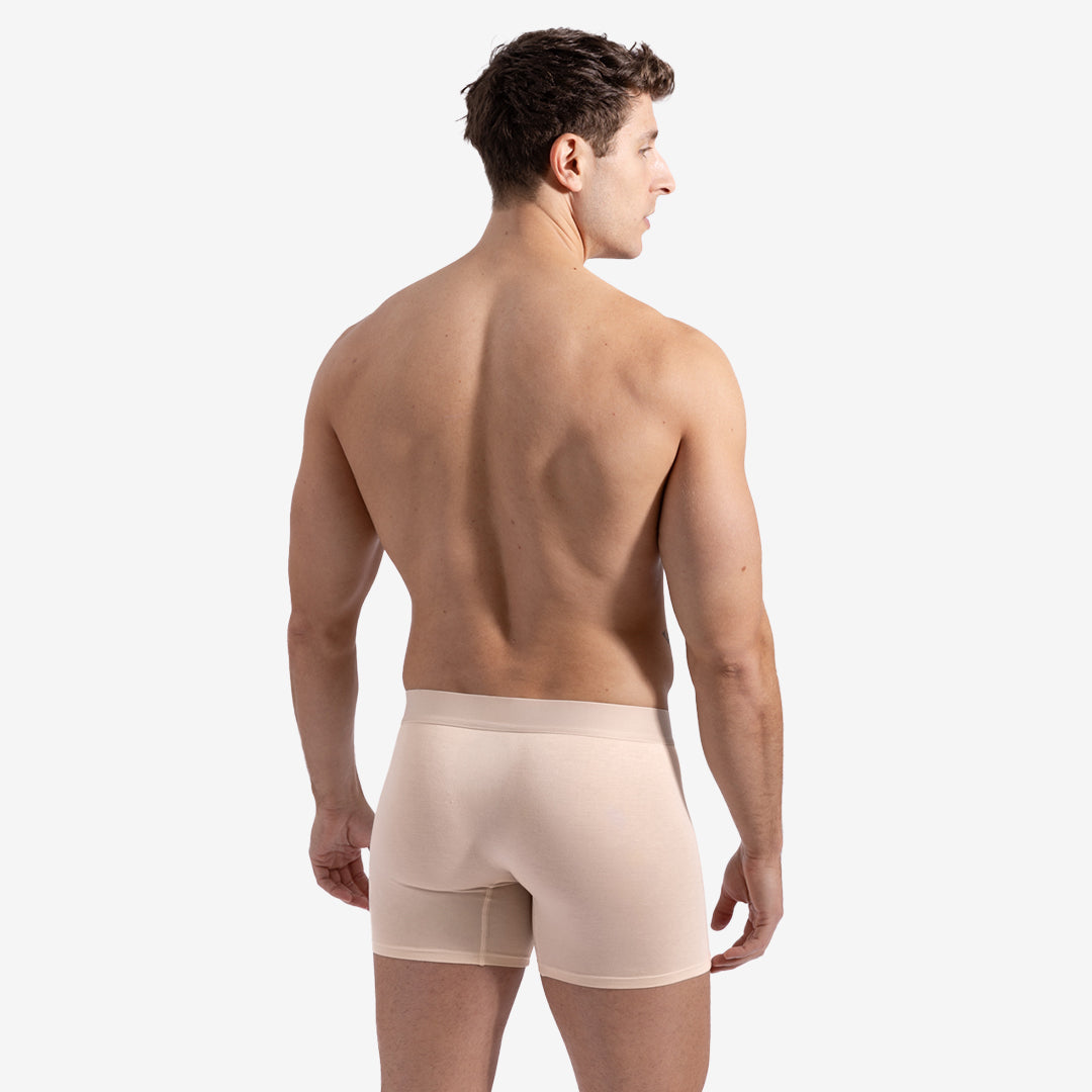 Man wearing beige boxer briefs on a white background