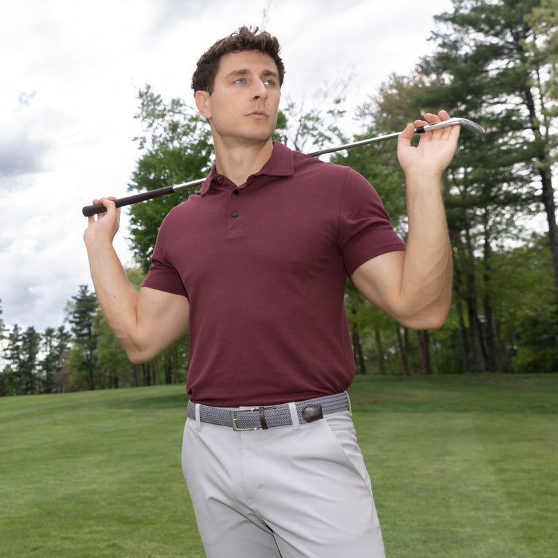 Man holding a golf club on a golf course