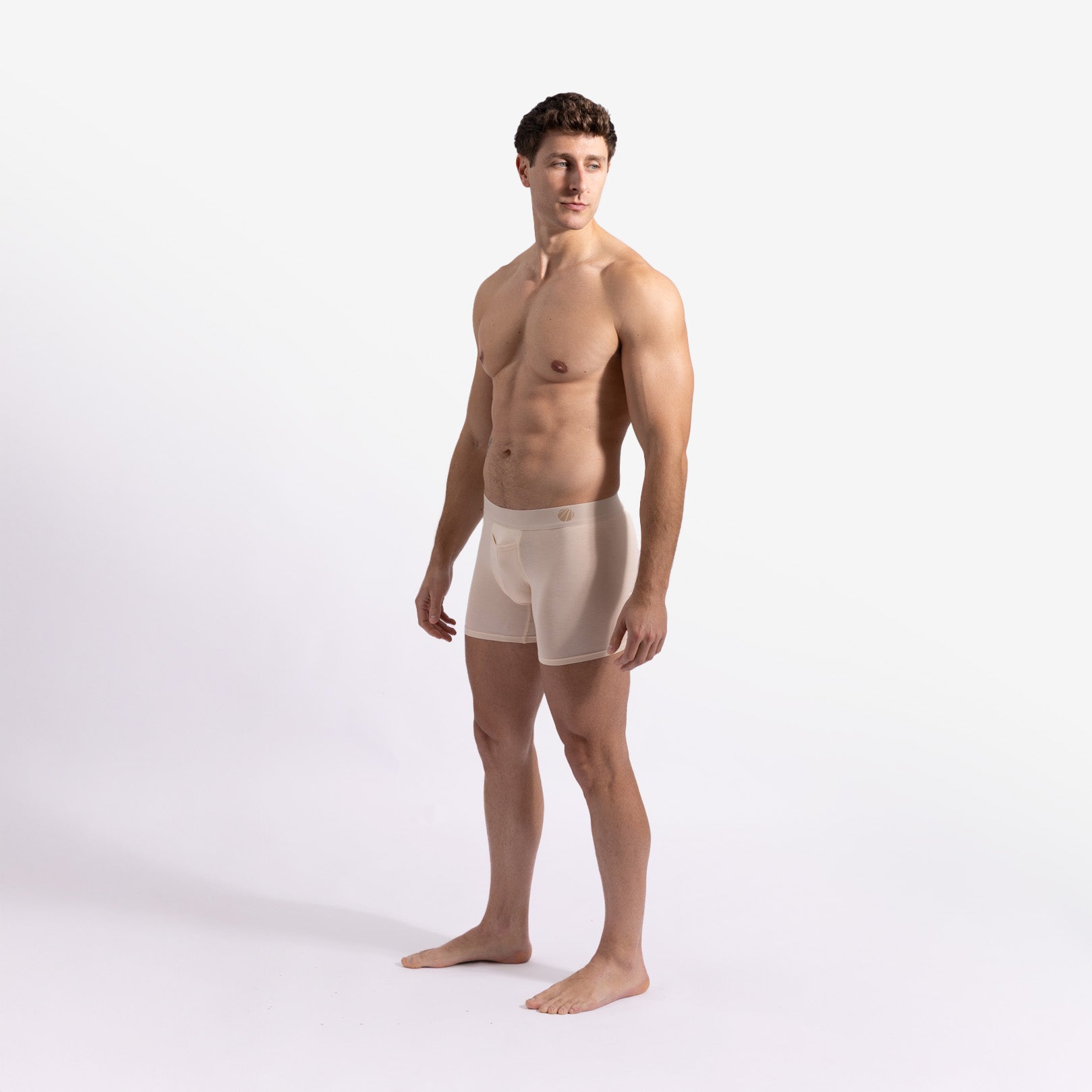 Man wearing beige boxer briefs on a white background